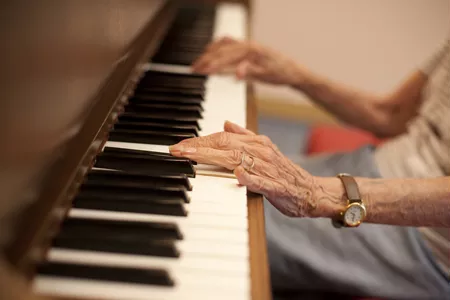 Résidente jouant du piano à l'EHPAD Les Aigueillères, maison de retraite près de Montpellier